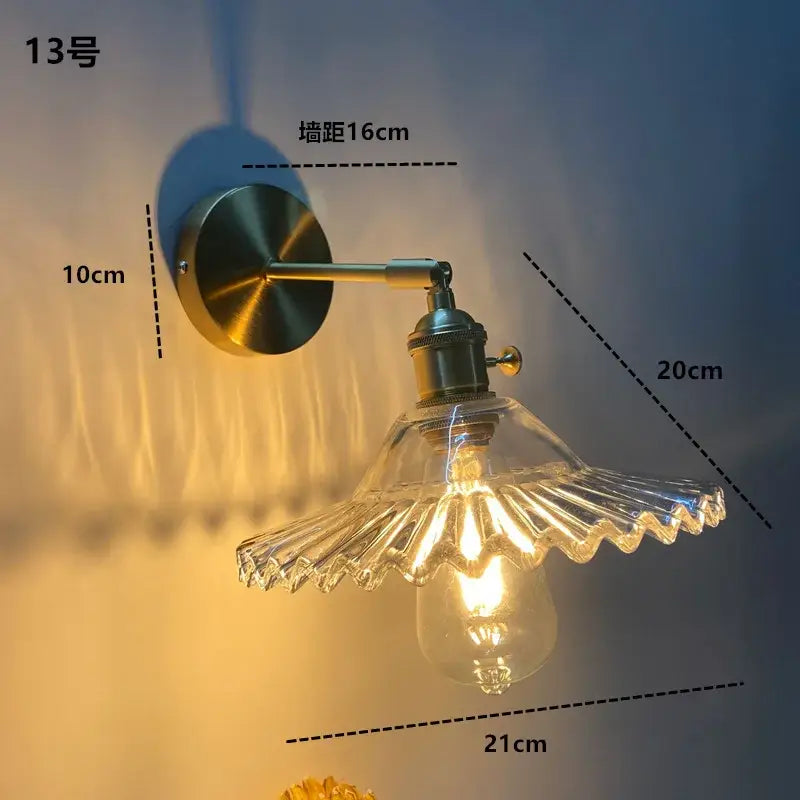Modern brass wall sconce with decorbites clear glass ruffled shade and exposed led edison bulb for bathroom lighting