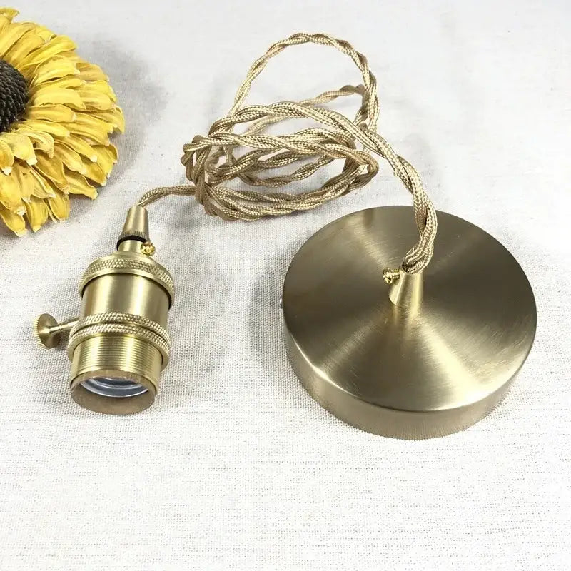 Modern brass textured glass led pendant light with brass finish and twisted beige fabric cord for kitchen use