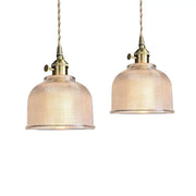 Modern brass textured glass led pendant light set featuring two brass pendant lights with translucent shades