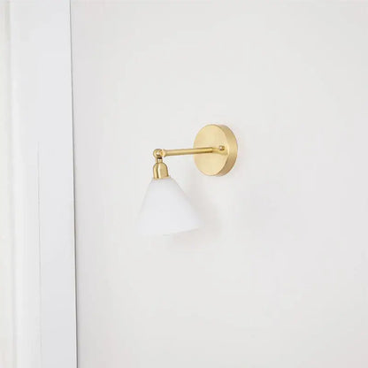 Modern brass wall lamp with gold-toned finish and frosted white shade for bedroom reading decorbites clear glass design