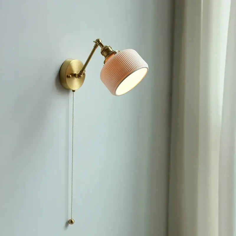 Modern brass wall lamp with ribbed peach ceramic shade and adjustable copper arm for bedroom reading light decorbites copper arm