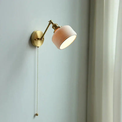 Modern brass wall lamp with ribbed peach ceramic shade and adjustable copper arm for bedroom reading light decorbites copper arm