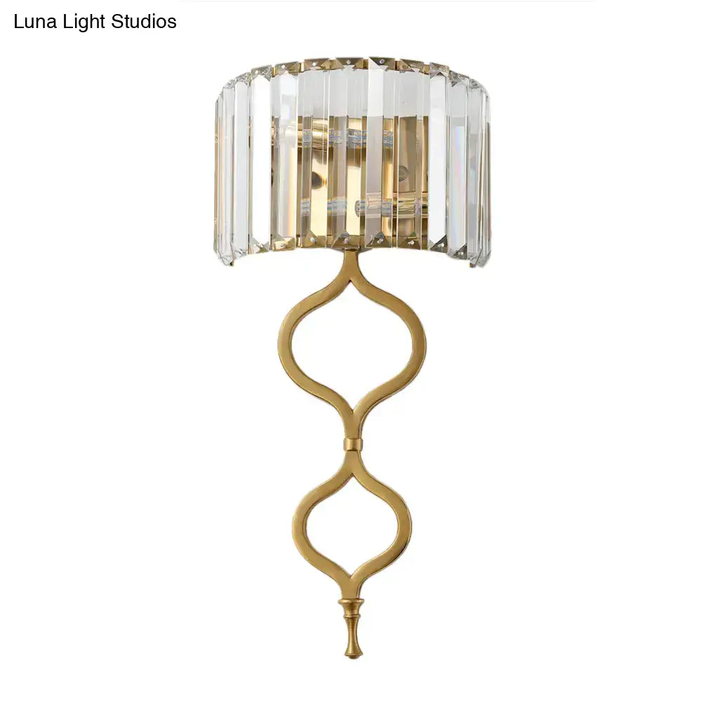 Modern brass wall sconce with crystal rectangle shade and gold-toned cascading design great choice for wall mount lighting