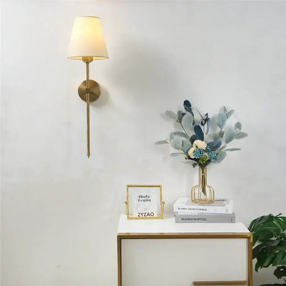 Modern brass wall sconce with gold touch led and cream fabric shade suitable for dining room decorbites gold touch
