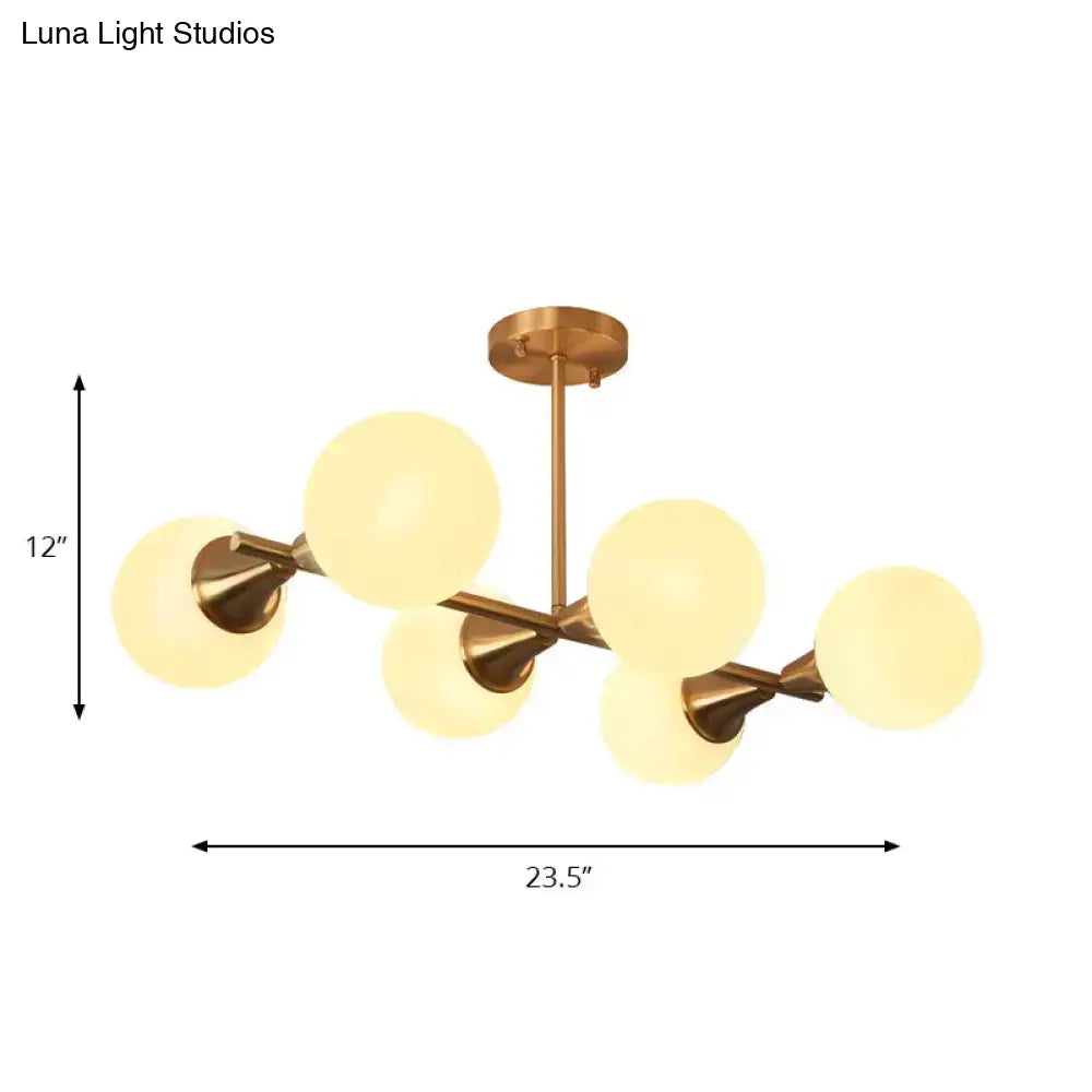 Brass-finished modern chandelier with six frosted glass globe shades for clear white bubble island light fixture