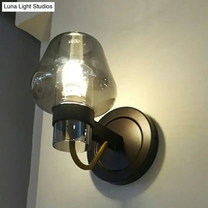 Modern bronze and brass smoke gray wall lamp with smoked glass shade black metal base and polished chrome fittings