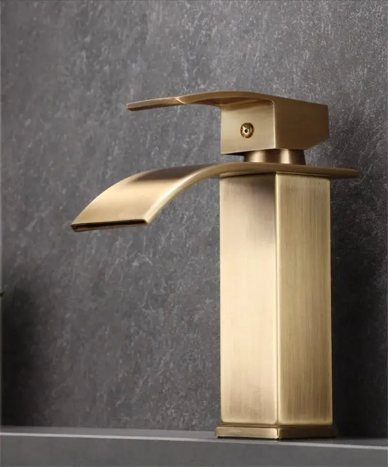 Modern bronze basin faucet with brass finish waterfall design and sleek rectangular spout for bathroom sink use
