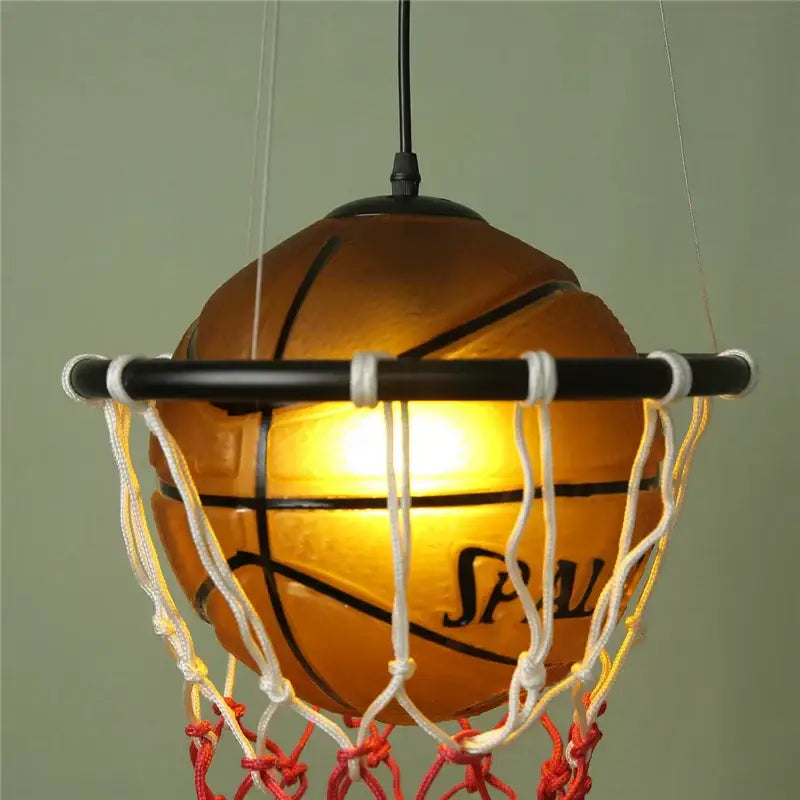Modern brown basketball pendant lights featuring a warm glowing spalding basketball pendant with white and red netting decorbites basketball pendant