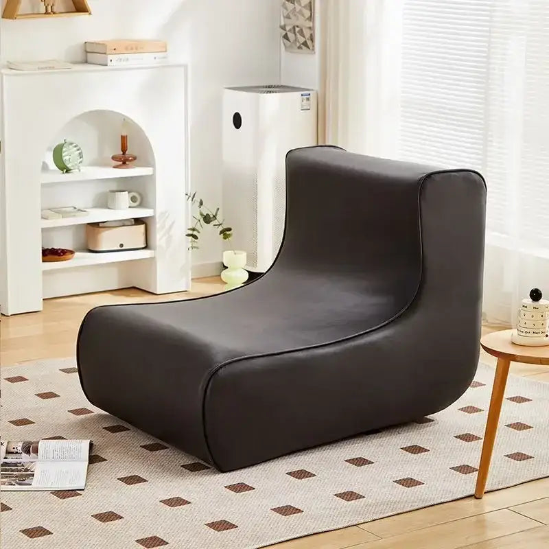 Modern brown and black faux leather cozy sofa chair with sleek curved contours for a stylish living room seating