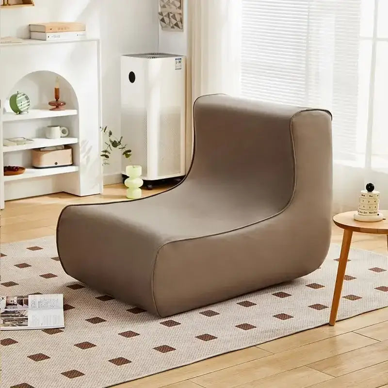 A sleek taupe upholstered cozy sofa chair with modern minimalist design for living room use