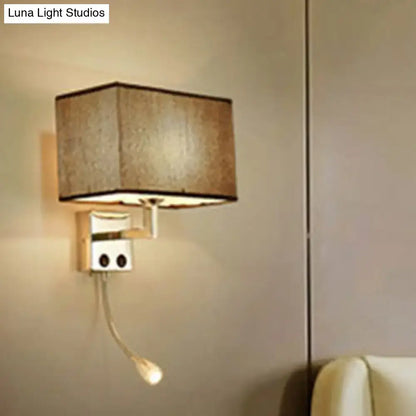 Modern brown and chrome bedroom spotlight wall lamp with a beige fabric rectangular lampshade and adjustable reading light
