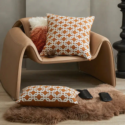 Tan leather armchair with curved modern design and decorbites brown coffee geometric cushion cover for living room