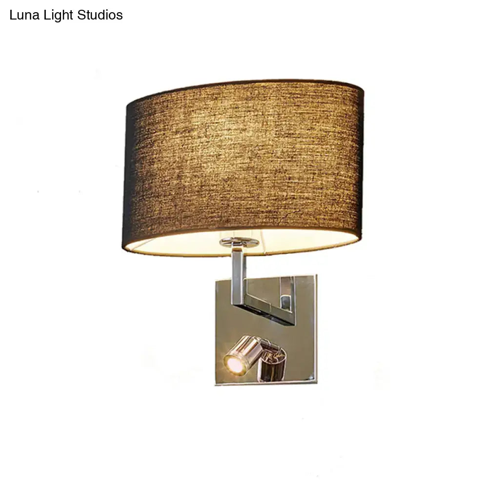 A modern wall light with a warm brown fabric shade and polished chrome accents designed as a bedroom sconce