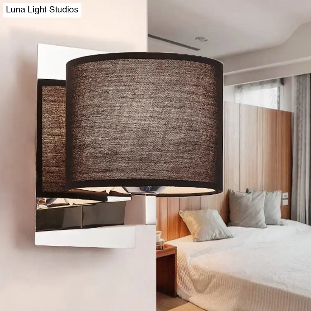 Modern brown fabric wall mount sconce with a cylindrical textured lampshade and sleek metallic base for bedroom lighting