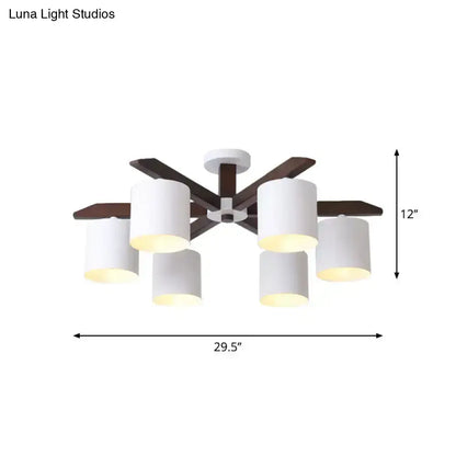 Modern brown and white ceiling mount chandelier with six cylindrical shades and dark wood arms for living room lighting by Luna Light Studios