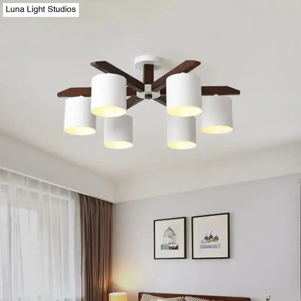 Modern brown and white ceiling mount chandelier with five white cylindrical shades and dark wood arms for living room