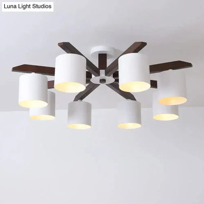 Modern brown and white ceiling mount chandelier with six white cylindrical shades and dark wood arms for living room