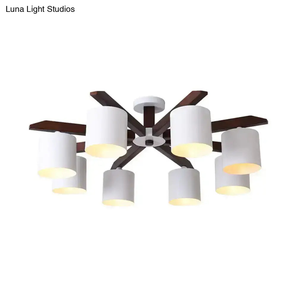 Modern brown and white ceiling mount chandelier with six cylindrical shades and dark wood arms for living room lighting