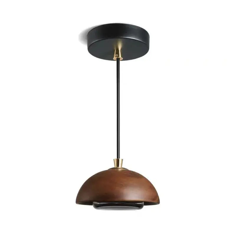 A modern brown finish pendant light with a dome-shaped wooden shade and black metal hardware for kitchen island