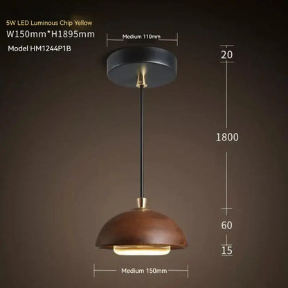 A warm yellow led pendant light with a matte brown wood dome shade and black metal hardware for kitchen island