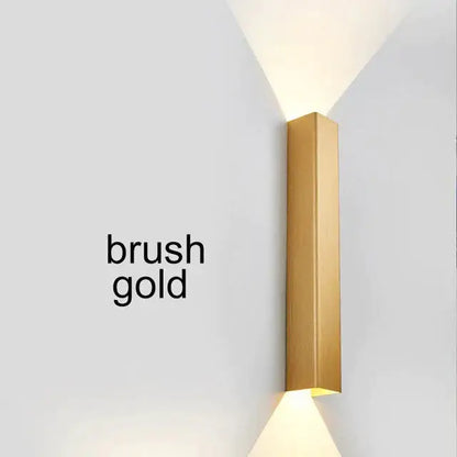 Modern brushed aluminum rectangular wall sconce in gold with minimalist design for ambient bedroom lighting