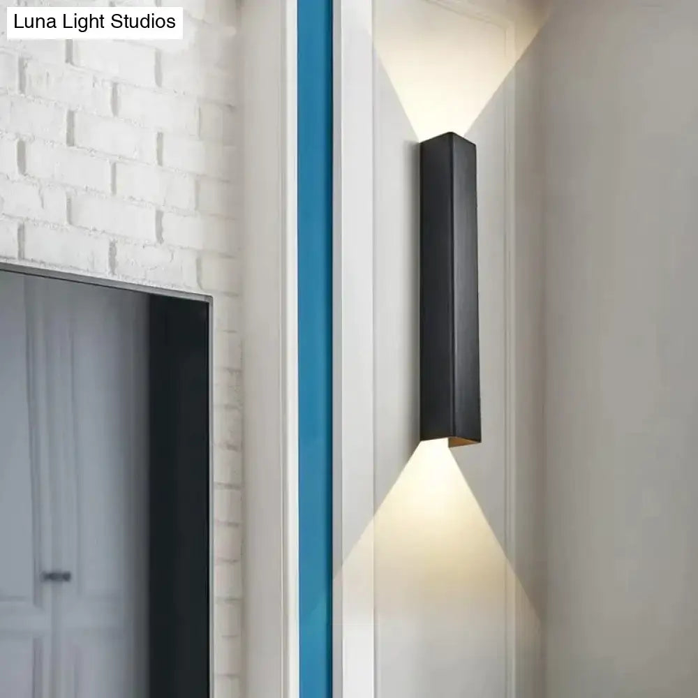 Black brushed aluminum wall sconce with sleek modern design for ambient bedroom lighting