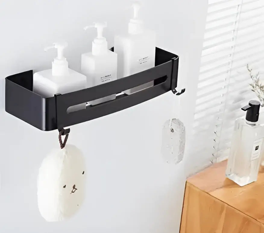 Black metal wall-mounted corner shelf holding three white pump bottles for bathroom shampoo decorbites brushed gold aluminum
