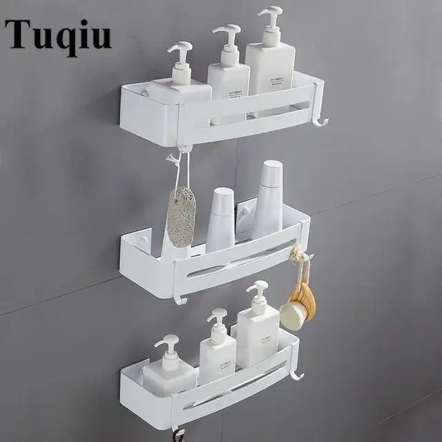 White plastic wall-mounted three-tier bathroom organizer with hooks and slots complementing decorbites brushed gold corner shelf