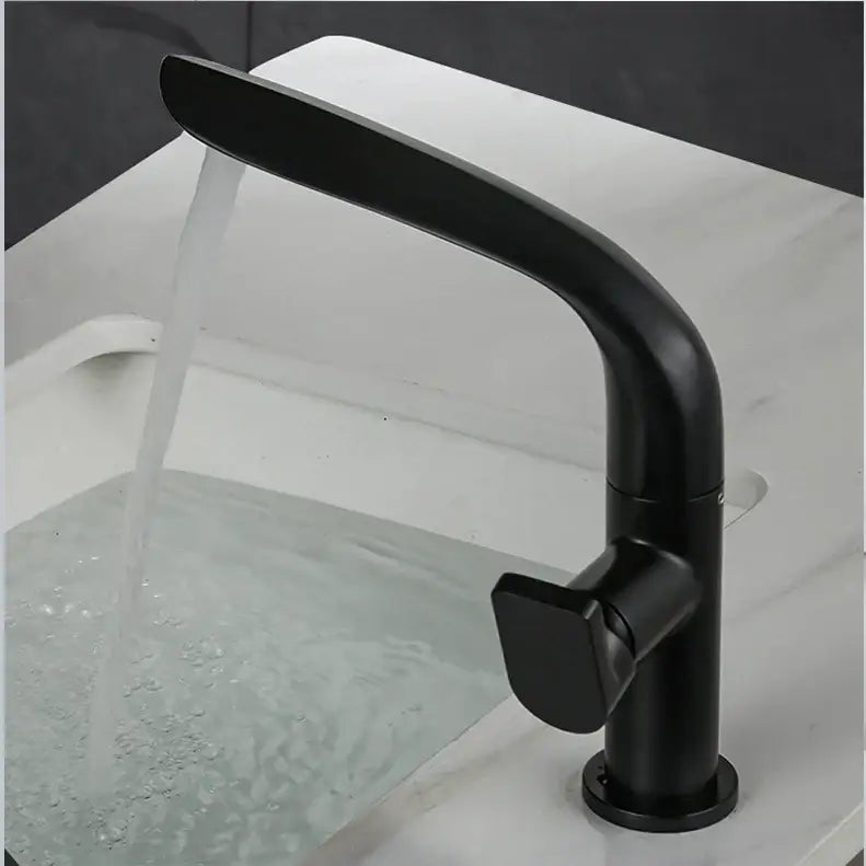 Modern brushed gold basin faucet with a black matte curved spout and rectangular handle decorbites brushed gold design