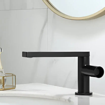 Black matte basin faucet with sleek rectangular spout and cylindrical handle complementing decorbites brushed gold style