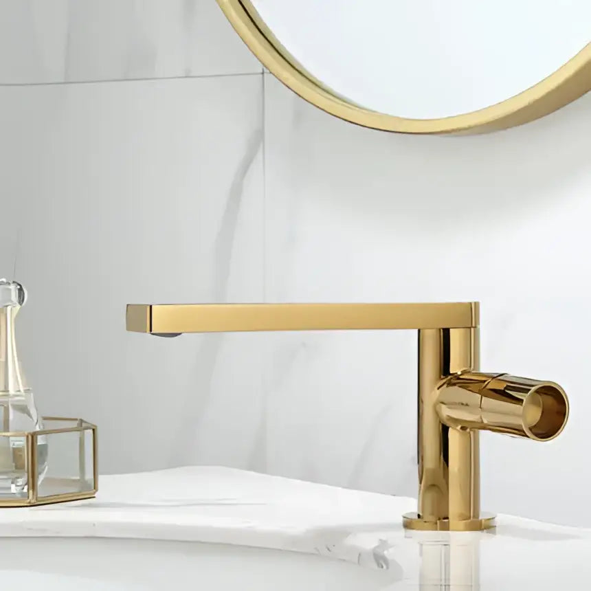 Modern brushed gold basin faucet with a sleek rectangular spout and cylindrical handle decorbites brushed gold design