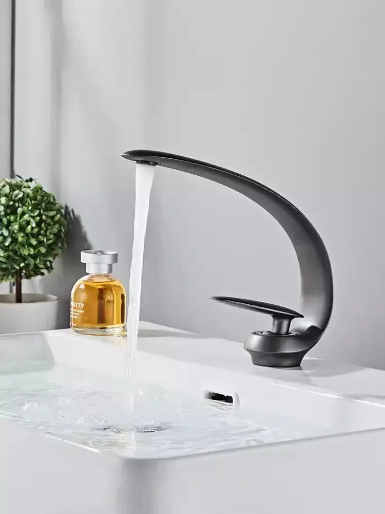 Modern brushed gold basin faucet with a sleek matte black curved design and single handle by decorbites brushed gold