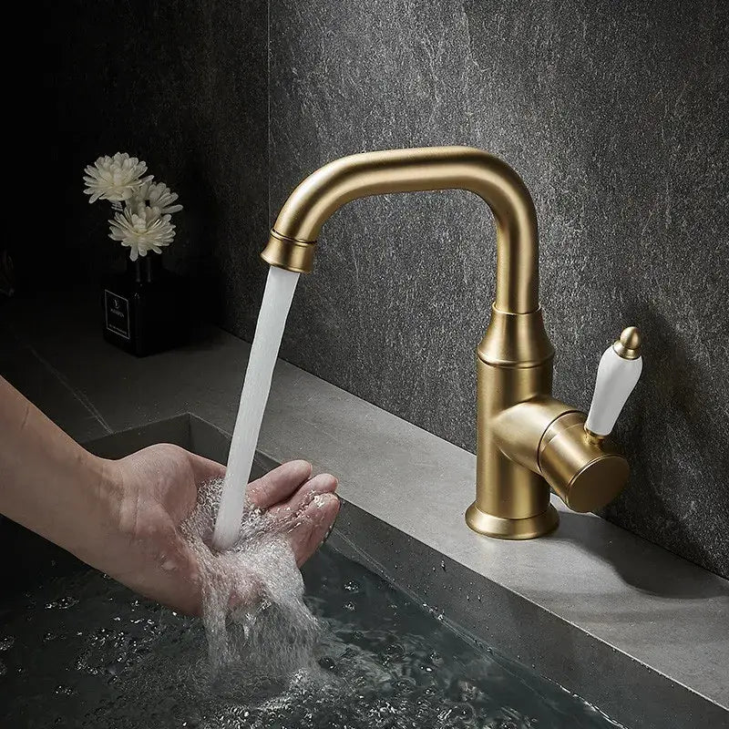 Modern brushed gold basin faucet with brass finish and white ceramic handle by decorbites for bathroom sink use