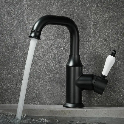 Black matte basin faucet with white ceramic handle contrasting modern brushed gold decorbites brushed gold design