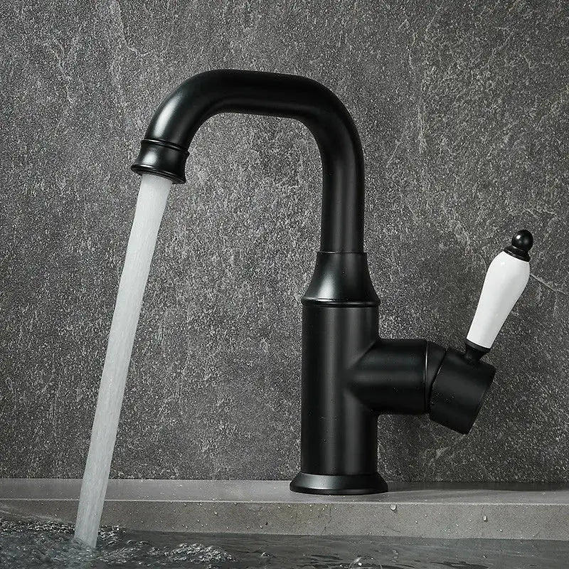 Black matte basin faucet with white ceramic handle contrasting modern brushed gold decorbites brushed gold design