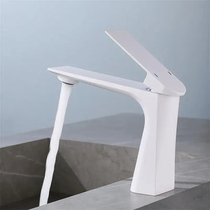 Modern white ceramic basin faucet with sleek angular design and waterfall spout in decorbites brushed gold finish