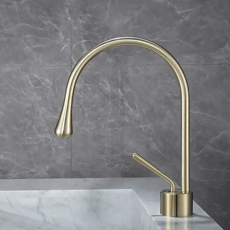 Modern brushed gold basin faucet with a sleek curved spout and minimalist design for kitchen use by decorbites brushed gold