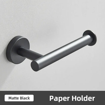 Matte black metal toilet paper holder with sleek modern design part of brushed gold bathroom accessories set stainless steel