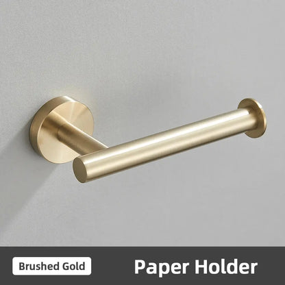 Brushed gold stainless steel toilet paper holder with sleek cylindrical design in modern bathroom accessories set