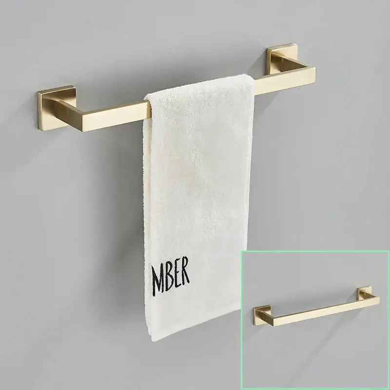 Modern brushed gold hardware set featuring a gold-toned rectangular towel rack with sleek square brackets design decorbites brushed gold