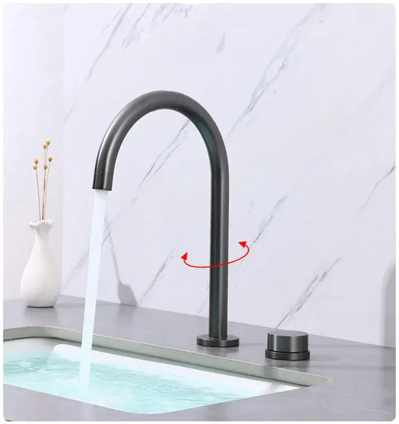 Modern brushed gold and black basin faucet with sleek curved spout and cylindrical matte black handles by decorbites
