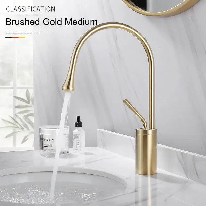 Modern brushed gold and black deck mounted basin tap bathroom faucet with sleek curved spout and cylindrical base single hole