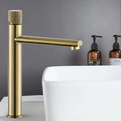 Modern brushed gold brass basin faucet with textured knurled handle and sleek cylindrical spout for bathroom sink