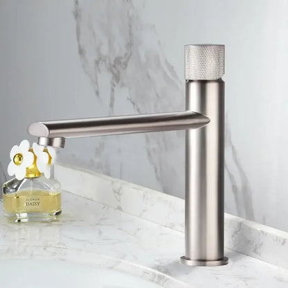Modern brushed gold brass basin faucet with a single-handle and textured diamond-patterned knob for bathroom sink use