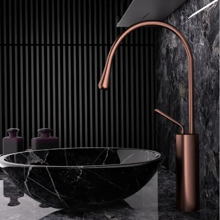 Modern brushed gold brass kitchen faucet with copper finish featuring a sleek curved spout and cylindrical base