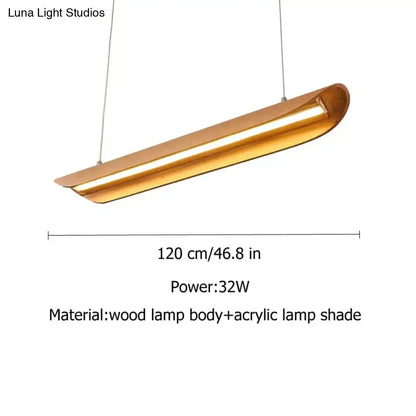 A modern brushed gold kitchen island light with a sleek elongated design perfect for chandeliers kitchen island use