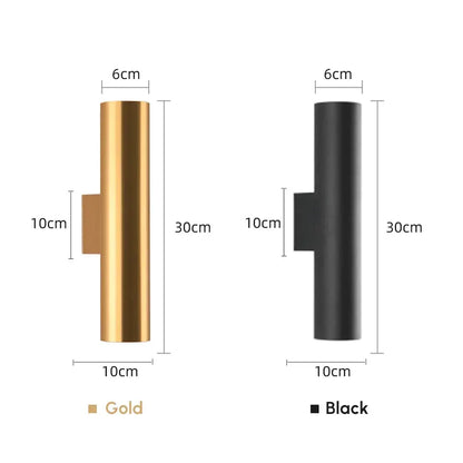 Modern brushed gold and matte black cylindrical wall lights featuring sleek finishes as bedroom wall lamps