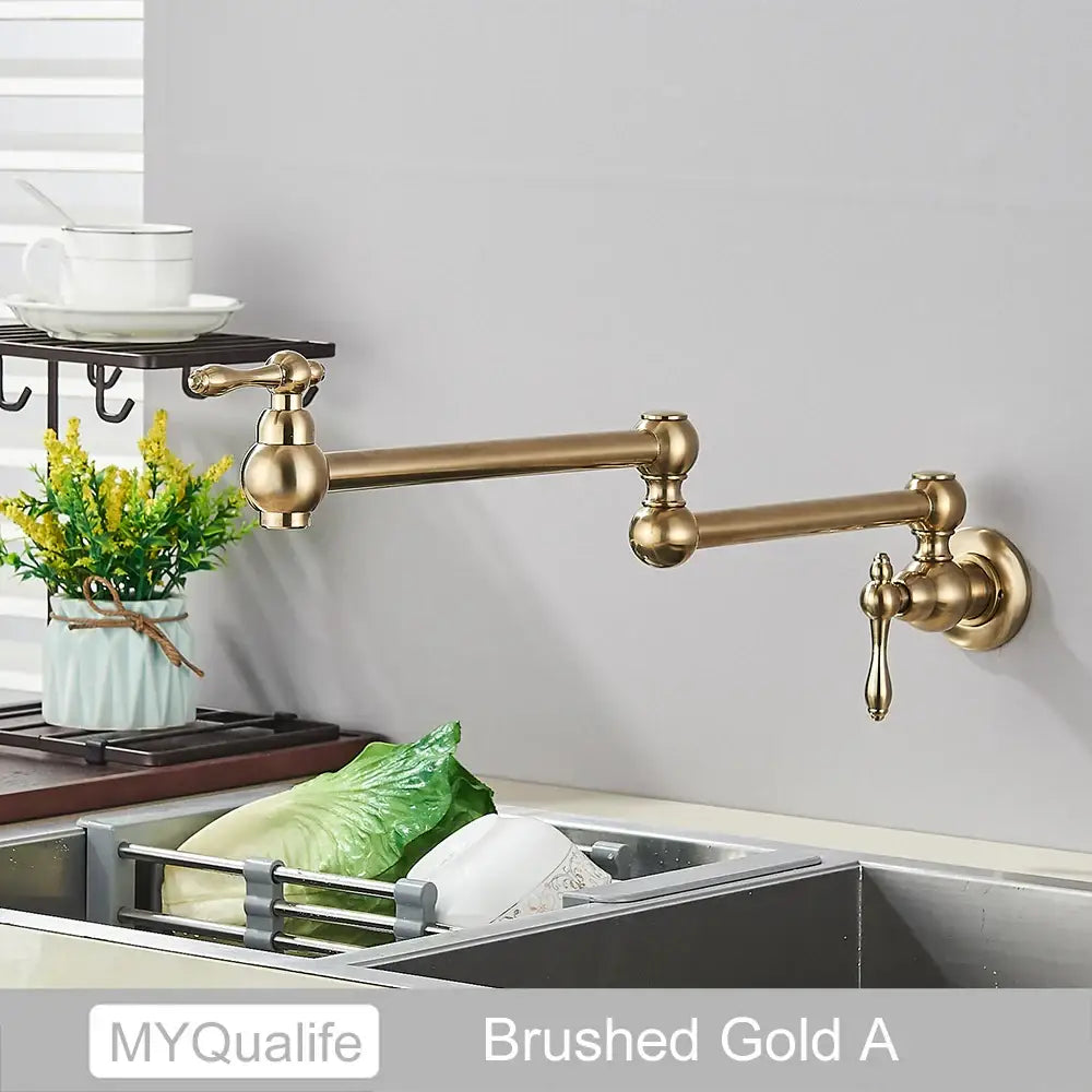 Modern brushed gold pot filler faucet with long extendable arm and ornate handles for kitchen use