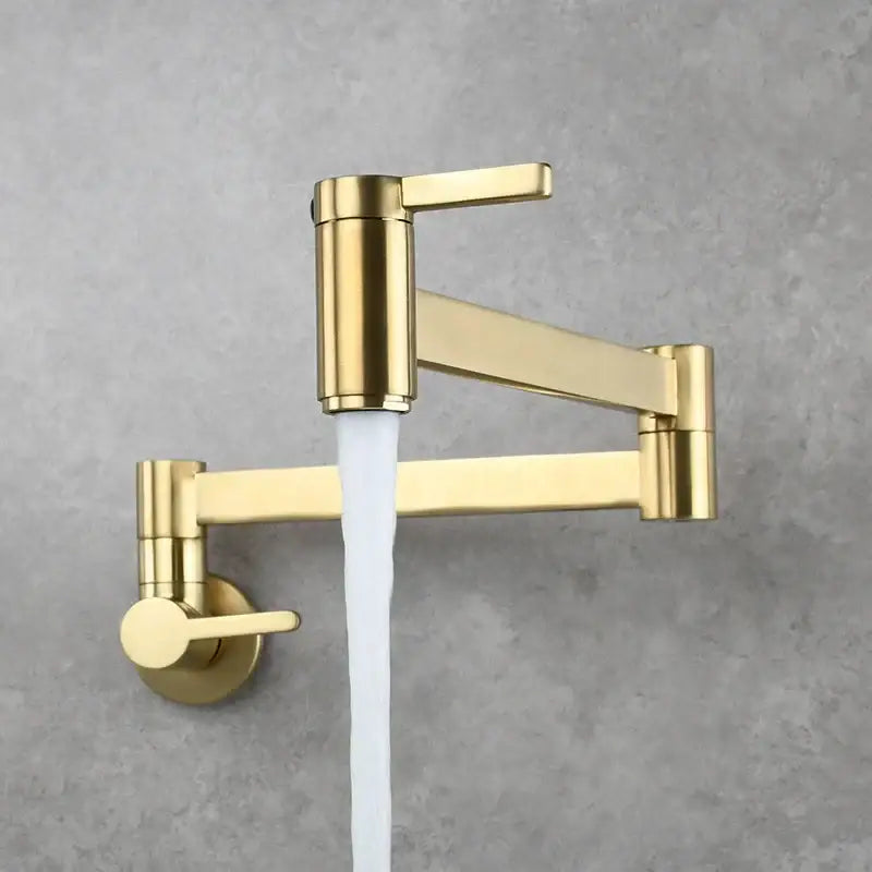 Modern brushed gold pot filler faucet with sleek articulated wall-mounted foldable spout and flowing water stream