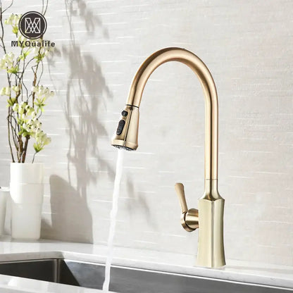 Brass-finished modern kitchen faucet with sleek curved spout and pull-down spray head by decorbites brushed gold
